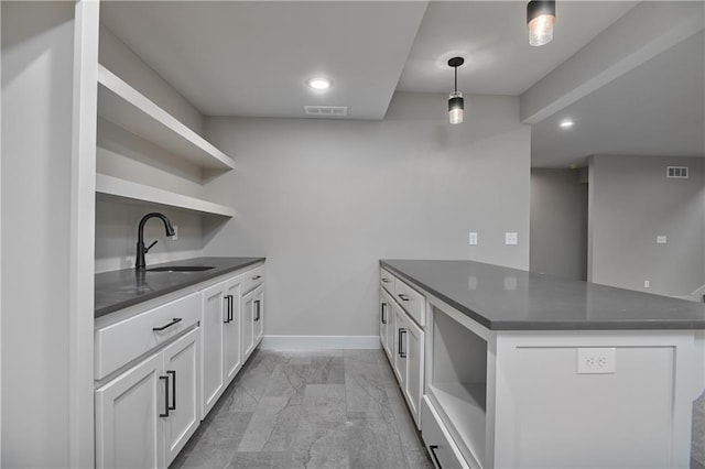 6113 Barth Rd, Shawnee, KS 66226 - kitchen featuring open shelves, a sink, dark countertops, a peninsula, and light marble finish flooring
