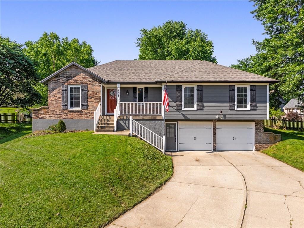 1405 7th Ct, Lees Summit, MO 64063 - single story home featuring covered porch, a garage, brick siding, and concrete driveway