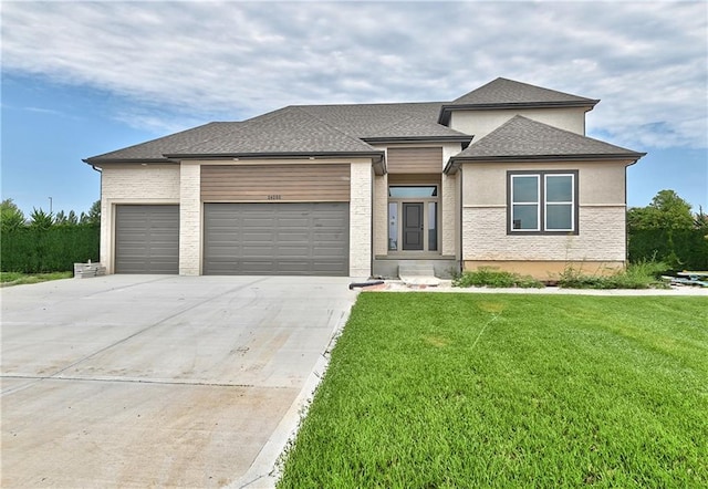 6039 Apache Dr, Shawnee, KS 66226 - prairie-style home with a garage, driveway, a front yard, roof with shingles, and stucco siding