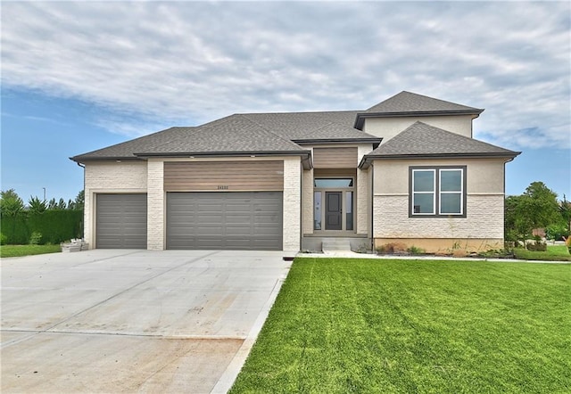 6039 Apache Dr, Shawnee, KS 66226 - prairie-style house with an attached garage, a front lawn, concrete driveway, and a shingled roof