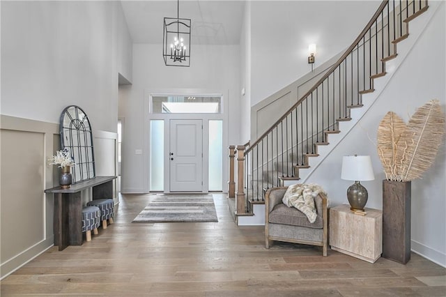 6039 Apache Dr, Shawnee, KS 66226 - foyer entrance featuring a high ceiling, stairway, wood finished floors, a chandelier, and baseboards