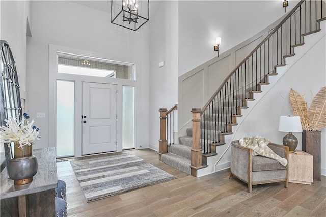 6039 Apache Dr, Shawnee, KS 66226 - entryway with a towering ceiling, stairs, wood finished floors, a chandelier, and baseboards