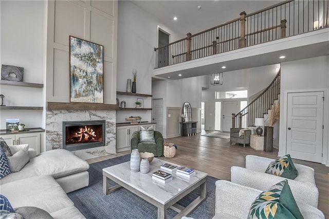 6039 Apache Dr, Shawnee, KS 66226 - living room with a towering ceiling, wood finished floors, a fireplace, stairs, and recessed lighting