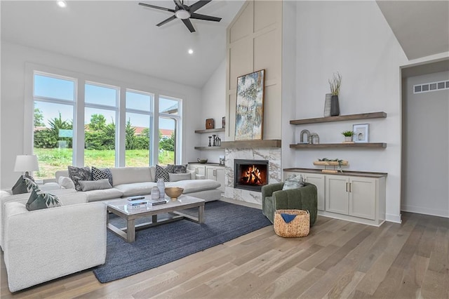 6039 Apache Dr, Shawnee, KS 66226 - living area with wood finished floors, a fireplace, high vaulted ceiling, a ceiling fan, and recessed lighting