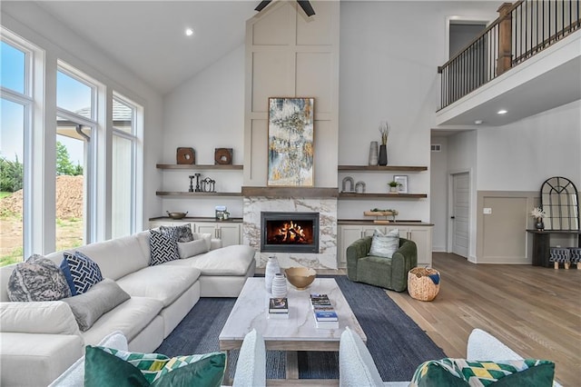 6039 Apache Dr, Shawnee, KS 66226 - living area with high vaulted ceiling, wood finished floors, a fireplace, and recessed lighting
