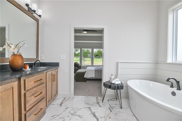 6039 Apache Dr, Shawnee, KS 66226 - ensuite bathroom with a freestanding bath, vanity, marble finish floors, and baseboards