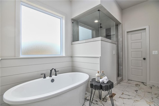 6039 Apache Dr, Shawnee, KS 66226 - bathroom with marble look tiles, a shower stall, and a freestanding bath