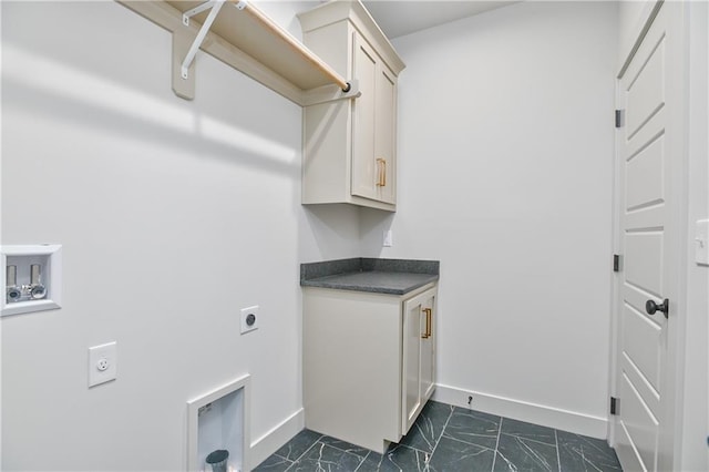6039 Apache Dr, Shawnee, KS 66226 - laundry room with electric dryer hookup, baseboards, dark marble finish floors, and cabinet space
