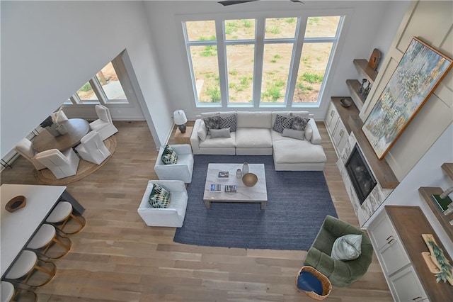6039 Apache Dr, Shawnee, KS 66226 - living room with wood finished floors, a fireplace, ceiling fan, and baseboards