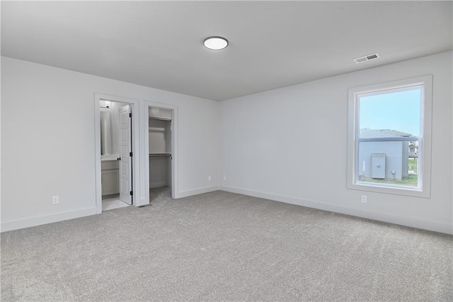 6039 Apache Dr, Shawnee, KS 66226 - unfurnished bedroom featuring baseboards, carpet, a walk in closet, and a closet