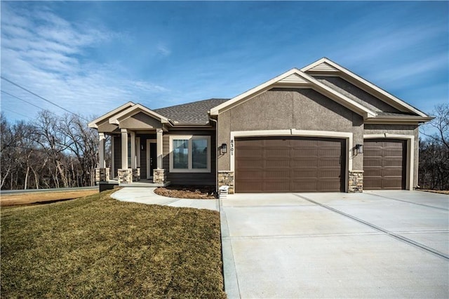 31432 W 85th Ter, De Soto, KS 66018 - view of front of house with a garage, stone siding, concrete driveway, a front yard, and stucco siding