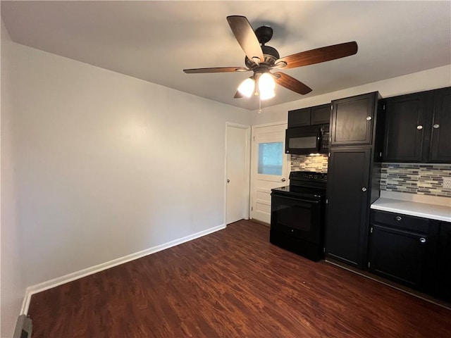 4215 Summit St, Leavenworth, KS 66048 - kitchen featuring black appliances, dark cabinetry, dark wood-style flooring, decorative backsplash, and light countertops