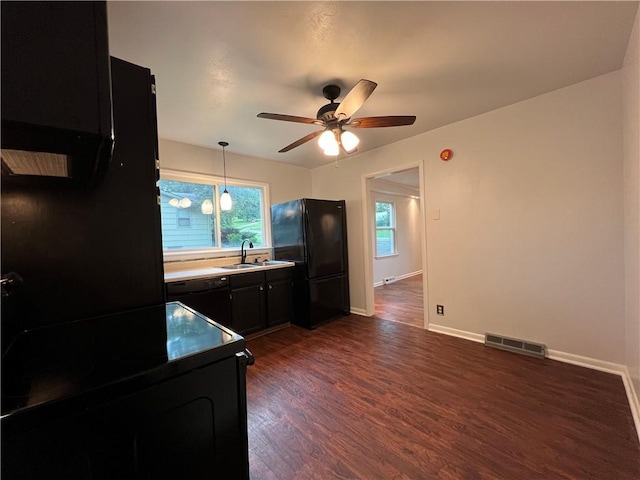 4215 Summit St, Leavenworth, KS 66048 - kitchen featuring black appliances, dark cabinetry, dark wood-type flooring, ceiling fan, and decorative light fixtures
