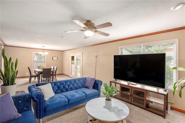 1307 W 30th St S, Independence, MO 64052 - living room featuring light colored carpet, baseboards, healthy amount of natural light, a chandelier, and a textured ceiling