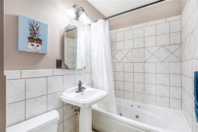 1307 W 30th St S, Independence, MO 64052 - full bathroom with tile walls, toilet, and a combined bath / shower with jetted tub