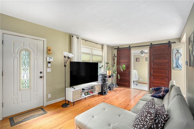 1307 W 30th St S, Independence, MO 64052 - living area with a barn door, wood finished floors, healthy amount of natural light, and a textured ceiling