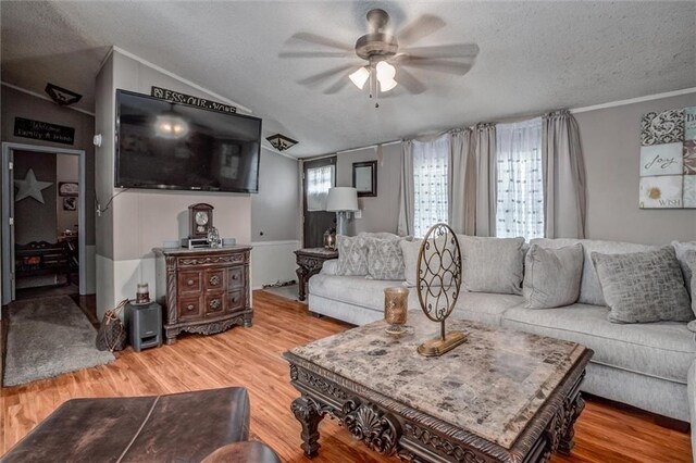 31965 Lakecrest Dr, Excelsior Springs, MO 64024 - living area featuring a textured ceiling, ceiling fan, wood finished floors, lofted ceiling, and ornamental molding