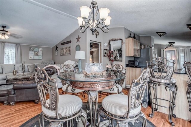 31965 Lakecrest Dr, Excelsior Springs, MO 64024 - dining area with ceiling fan, light wood-style floors, a chandelier, and lofted ceiling
