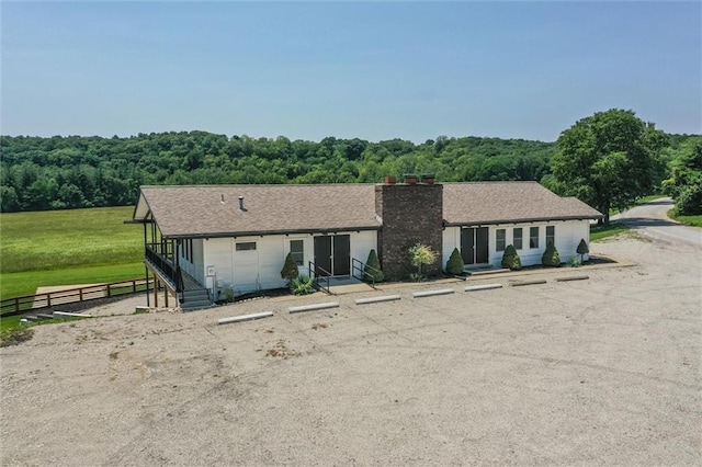 31965 Lakecrest Dr, Excelsior Springs, MO 64024 - single story home with uncovered parking, a chimney, and a view of trees