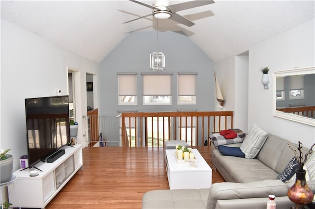 7833 Garnett St, Lenexa, KS 66214 - living room with a ceiling fan, lofted ceiling, wood finished floors, and a chandelier