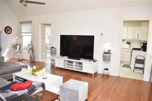 7833 Garnett St, Lenexa, KS 66214 - living room with ceiling fan, wood finished floors, baseboards, and lofted ceiling