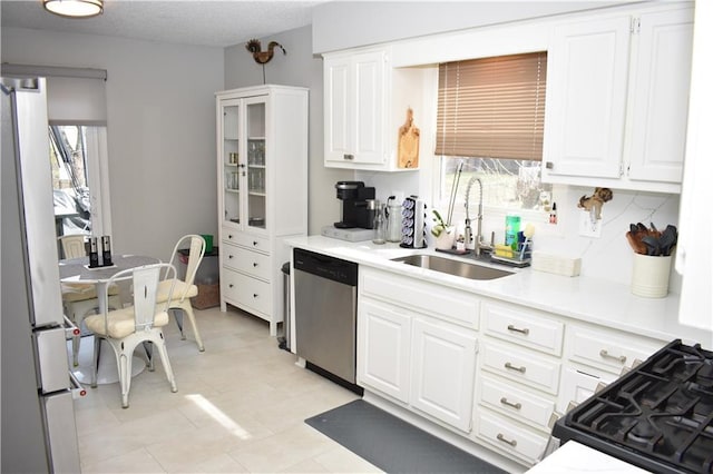 7833 Garnett St, Lenexa, KS 66214 - kitchen with dishwasher, a sink, plenty of natural light, and freestanding refrigerator