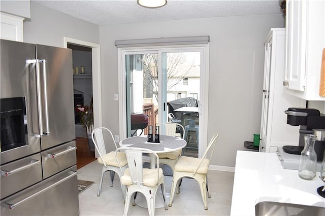 7833 Garnett St, Lenexa, KS 66214 - dining space with baseboards and a textured ceiling