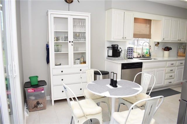 7833 Garnett St, Lenexa, KS 66214 - kitchen featuring dishwasher, a sink, white cabinets, and light countertops