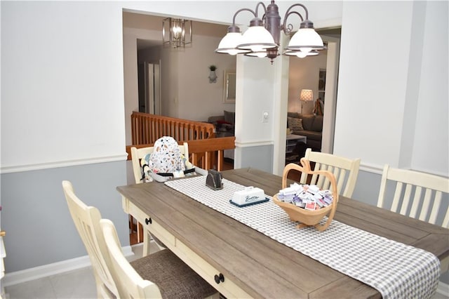 7833 Garnett St, Lenexa, KS 66214 - tiled dining space featuring a chandelier and baseboards