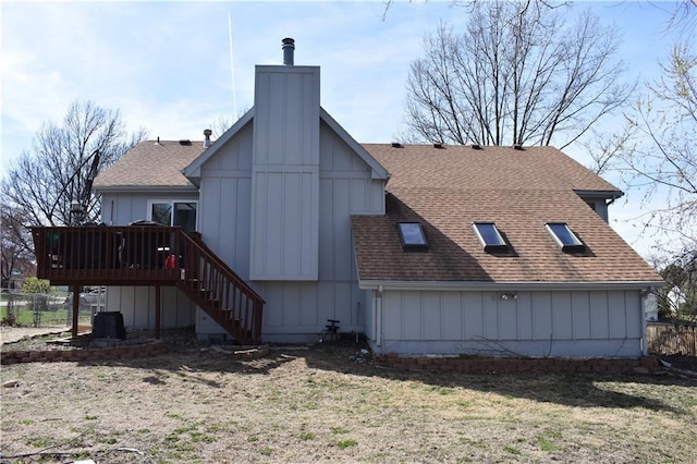 7833 Garnett St, Lenexa, KS 66214 - back of property featuring roof with shingles, a deck, and stairs