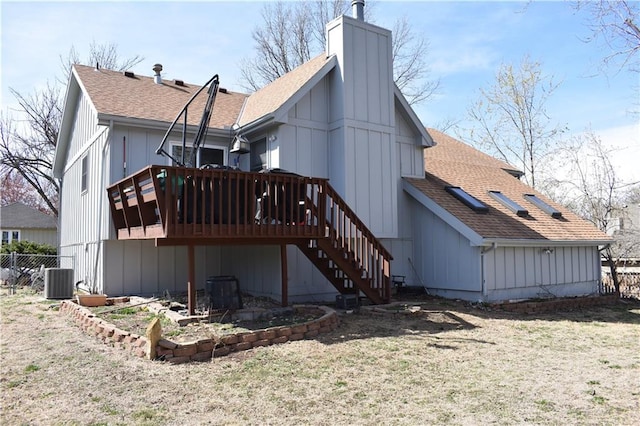 7833 Garnett St, Lenexa, KS 66214 - rear view of property with a shingled roof, stairway, a wooden deck, a chimney, and cooling unit
