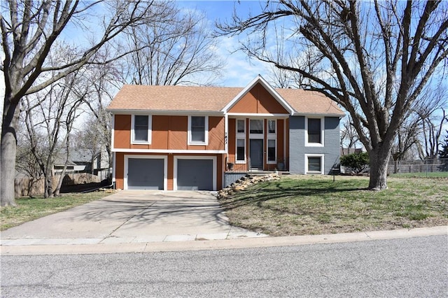 7833 Garnett St, Lenexa, KS 66214 - view of front facade featuring driveway, a garage, and a shingled roof