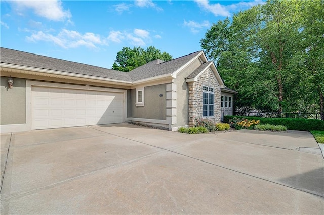 812 E 110th Ter, Kansas City, MO 64131 - view of front facade with concrete driveway, stone siding, a garage, and stucco siding