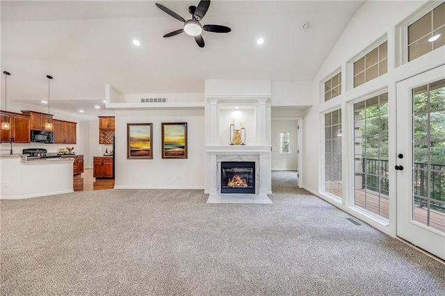 812 E 110th Ter, Kansas City, MO 64131 - unfurnished living room with light colored carpet, ceiling fan, plenty of natural light, recessed lighting, and a high end fireplace