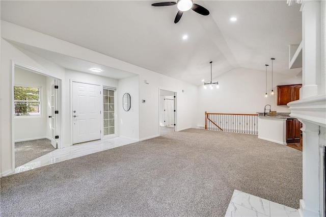 812 E 110th Ter, Kansas City, MO 64131 - unfurnished living room featuring ceiling fan, light colored carpet, lofted ceiling, and a chandelier