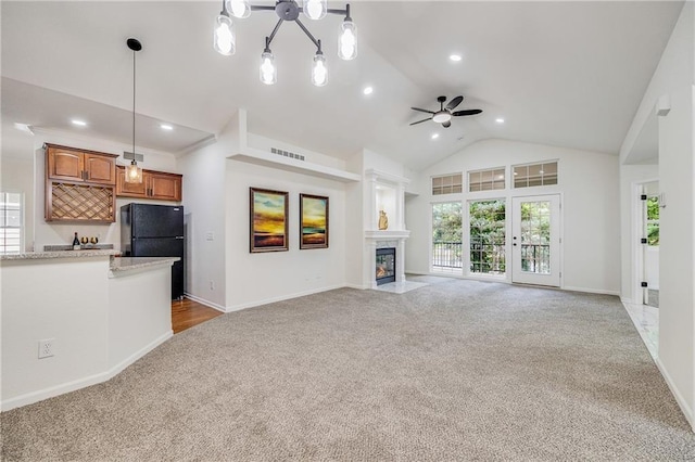812 E 110th Ter, Kansas City, MO 64131 - unfurnished living room featuring light colored carpet, ceiling fan, a glass covered fireplace, high vaulted ceiling, and recessed lighting