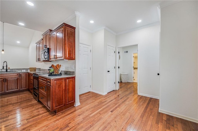 812 E 110th Ter, Kansas City, MO 64131 - kitchen featuring black appliances, light wood-style floors, stone countertops, crown molding, and hanging light fixtures