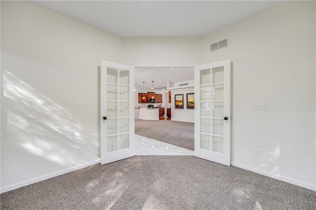 812 E 110th Ter, Kansas City, MO 64131 - spare room with french doors and carpet