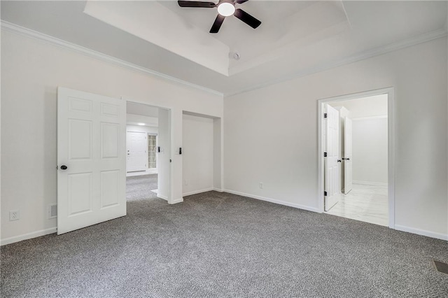 812 E 110th Ter, Kansas City, MO 64131 - unfurnished bedroom featuring a tray ceiling, carpet flooring, crown molding, and ceiling fan