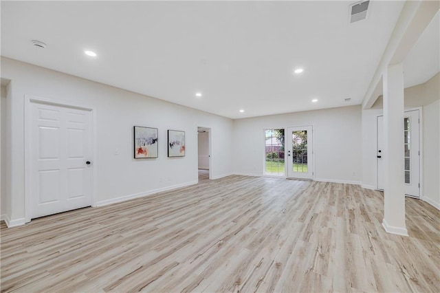 812 E 110th Ter, Kansas City, MO 64131 - unfurnished living room featuring light wood-type flooring and recessed lighting