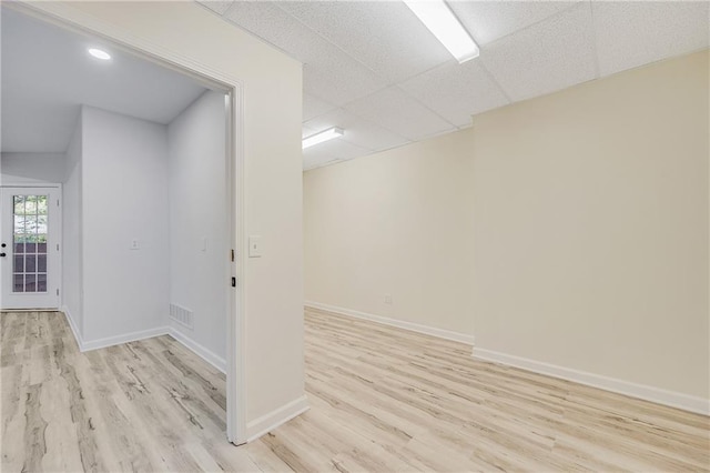 812 E 110th Ter, Kansas City, MO 64131 - unfurnished room featuring light wood-style flooring and a paneled ceiling