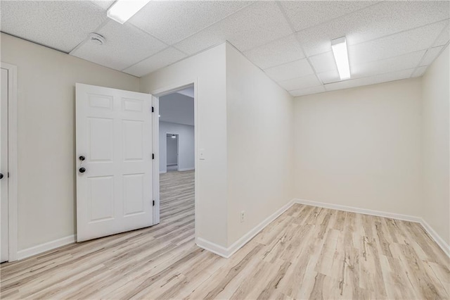 812 E 110th Ter, Kansas City, MO 64131 - unfurnished room featuring a drop ceiling and wood finished floors