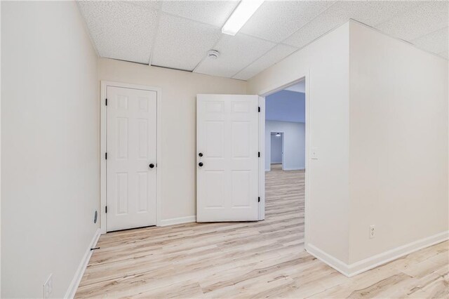 812 E 110th Ter, Kansas City, MO 64131 - spare room with a drop ceiling and light wood-type flooring