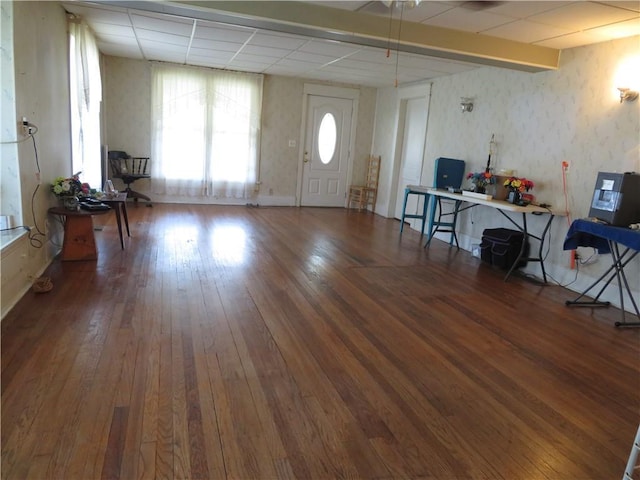 201 E Ottawa St, Paola, KS 66071 - living room with wallpapered walls, wood-type flooring, and a drop ceiling