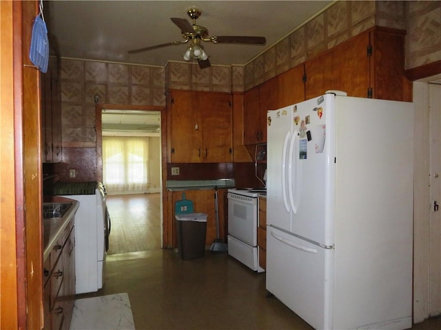 201 E Ottawa St, Paola, KS 66071 - kitchen featuring white appliances, ceiling fan, brown cabinetry, and dark countertops