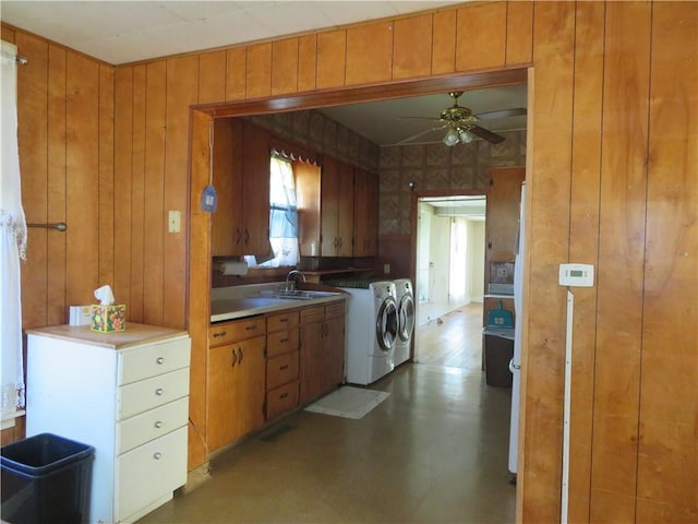 201 E Ottawa St, Paola, KS 66071 - washroom with separate washer and dryer, cabinet space, a ceiling fan, and wood walls