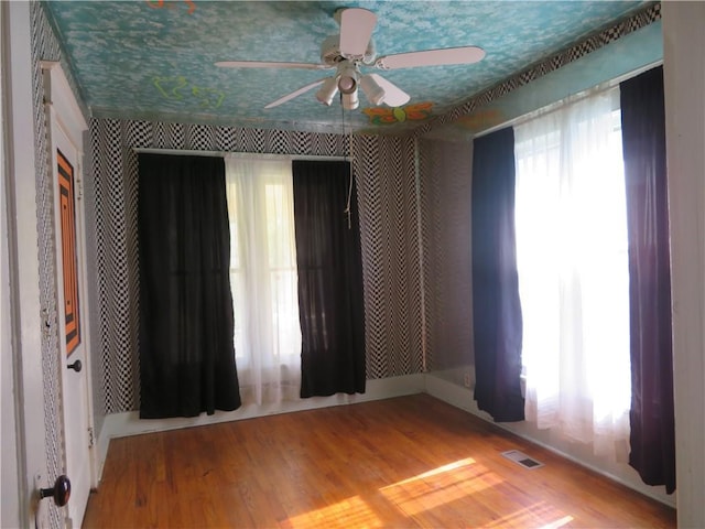 201 E Ottawa St, Paola, KS 66071 - unfurnished bedroom featuring wood finished floors and a ceiling fan