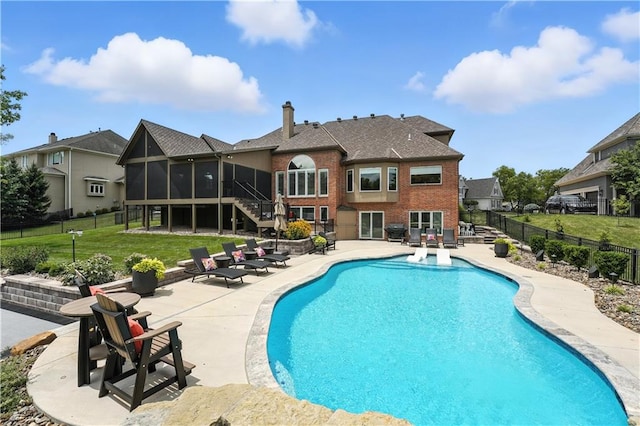 9905 W 144th St, Overland Park, KS 66221 - view of swimming pool featuring a sunroom, a patio, a fenced backyard, and stairs