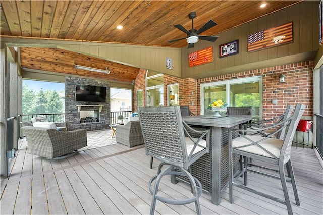 9905 W 144th St, Overland Park, KS 66221 - wooden deck with an outdoor living space with a fireplace, a ceiling fan, and outdoor dining area