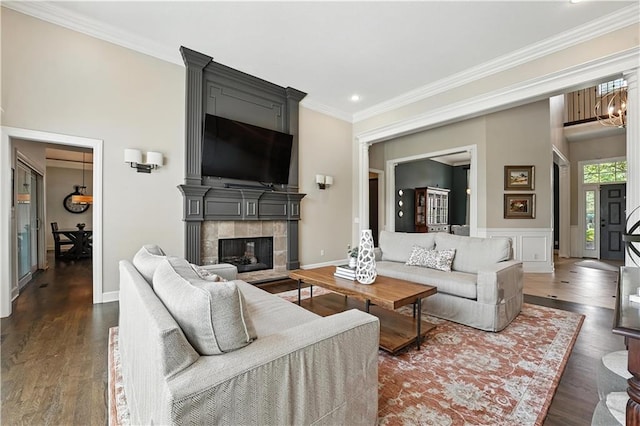 9905 W 144th St, Overland Park, KS 66221 - living room featuring dark wood-type flooring, crown molding, recessed lighting, a tile fireplace, and a chandelier